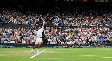 Tennis player serves at a packed stadium, illustrating dynamic engagement, featured on the About Engage page.